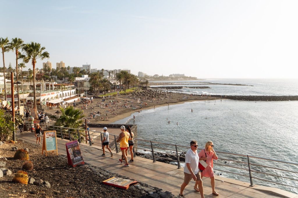 tropical-beachfront-in-tenerife-spain-30327834 Relaxing beachfront scene in Tenerife, Spain, with beachgoers enjoying sunny weather.